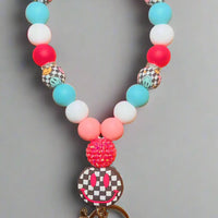 Wristlet keychain with Checkered Smiley Focal Colors: Baby Pink, Hot Pink, Turquoise, White, and Checkered Smiley K's Crafty Vibes Co.