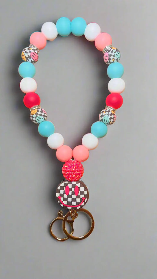 Wristlet keychain with Checkered Smiley Focal Colors: Baby Pink, Hot Pink, Turquoise, White, and Checkered Smiley K's Crafty Vibes Co.